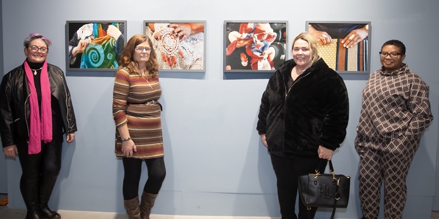 Women in front of mounted photographs